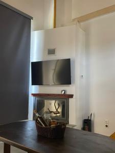 a living room with a fireplace with a tv above it at Faos residence I in Pefkias