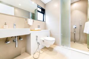 a bathroom with a toilet and a sink and a shower at The Zenith Luxuary in Patna