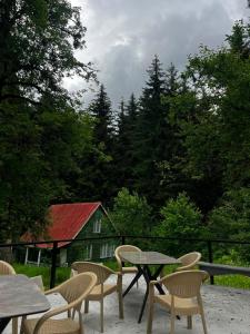 a patio with tables and chairs and a barn at Ord INN in Oni +10 photos