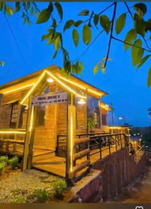 a log cabin with lights on the front of it at Thông house 2 in Kon Von Kla