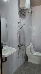 a bathroom with a shower and a toilet and a sink at Thông house 2 in Kon Von Kla