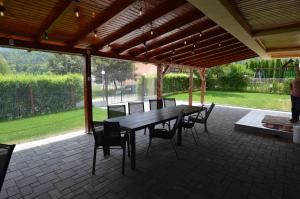 a wooden table and chairs on a patio at Pensiunea Mountain King in Sâmbăta de Sus