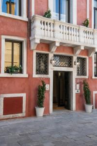 a building with a balcony on the side of it at Palazzo De Polo in Venice