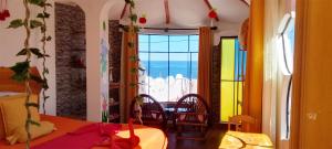 a dining room with a table and a view of the ocean at Jardín Andino Hostal in Copacabana