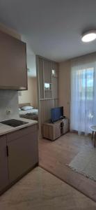 a room with a kitchen and a living room at Sea&Sunset Studio in Sozopol