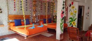 two beds in a room with blue pillows at Jardín Andino Hostal in Copacabana +64 photos