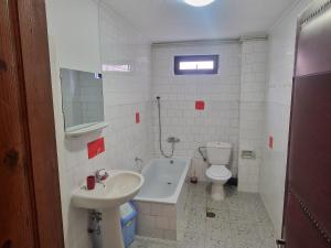 a white bathroom with a sink and a toilet at Casa Ursilor in Predeal +45 photos