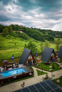 an overhead view of a house with a swimming pool at Mălinului Resort and Spa in Bughea de Sus