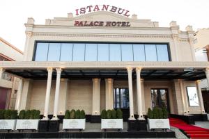 a large building with a sign on top of it at Istanbul Palace Hotel in Urganch +26 photos