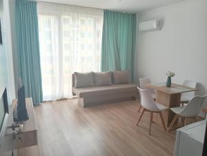 a living room with a couch and a table at Kristan in Sveti Vlas