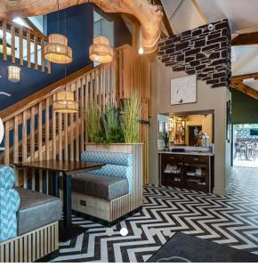 a lobby with a staircase and a table and chairs at Caravan no 69 in Cwm-y-glo