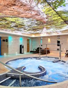 a hot tub in the middle of a building with a ceiling at Caravan no 69 in Cwm-y-glo