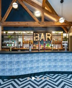 a bar at a restaurant with blue tiles at Caravan no 69 in Cwm-y-glo