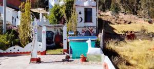 a house with a gate and a fire hydrant in front at Jardín Andino Hostal in Copacabana