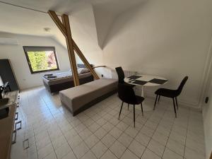 a bedroom with a bed and a table and chairs at Dózsa Vendégház in Balatonboglár