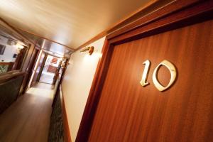 a door with the number on it in a hallway at Passengerschip Princesse Royal in Groningen