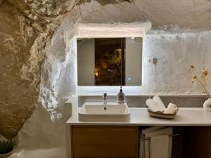 a bathroom with a sink and a mirror at La Cueva De Orel in Molinicos +14 photos