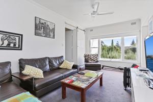 a living room with a couch and a table at Barossa White House The West Wing in Angaston