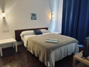 a bedroom with a bed with two towels on it at Pension Casín in Ribadesella