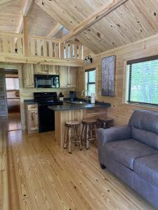 a kitchen and living room in a log cabin at Tiny Cabin #1 by Windham NY Escape 'Catskill Gem' in Hensonville