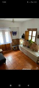 a living room with two windows and a tiled floor at Casa Aire del Sur in Órgiva