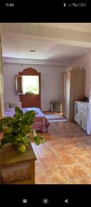a bedroom with a bed and a table and a window at Casa Aire del Sur in Órgiva