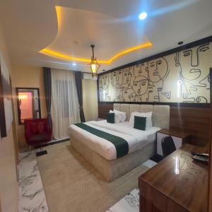 a hotel room with a bed and a desk at Classy Castle Hotel And Suite in Ughelli
