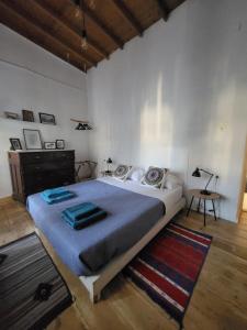 a bedroom with a large bed and a rug at Manolia House in Parikia