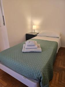 a bedroom with a bed with a towel on it at La Felce in Cernobbio