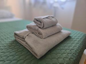 a pile of towels sitting on top of a bed at La Felce in Cernobbio +52 photos