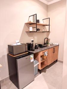 a kitchen with a sink and a refrigerator at Die Boord Guesthouse in Crocodile Valley Estates