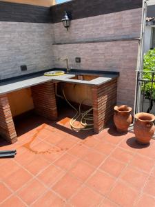 a kitchen with a sink on a patio at la dimora del centro in Zafferana Etnea