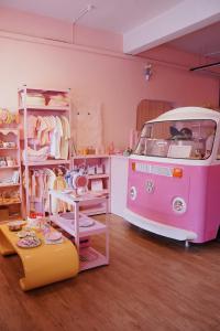 a room with a pink van parked in a room at Hugstore Pink Hotel in George Town
