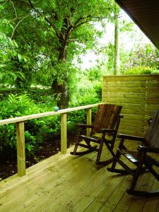 a wooden bench sitting on a wooden deck at An Garraí Mór in Omagh