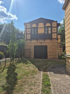 a brick house with a balcony on top of it at PP Pension Potsdam in Potsdam