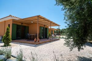 a home with a patio with a table and chairs at Eleon Olive Retreat - Skourochori in Katakolo