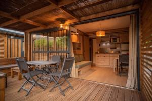 a dining room and kitchen with a table and chairs at Bungalows Peña Montañesa in Aínsa
