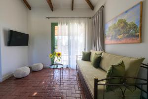 a living room with a couch and a window at Eleon Olive Retreat - Skourochori in Katakolo