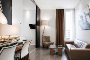 a living room with a couch and a table at VISIONAPARTMENTS Berlin - self check-in in Berlin