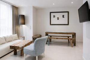 a living room with a couch and a table at VISIONAPARTMENTS Berlin - self check-in in Berlin