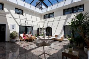 a courtyard with a fountain in the middle of a building at ApartHotel Vila Minka in Ljubljana