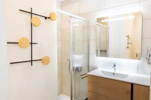 a bathroom with a sink and a shower at Cocon d'Altitude avec Terrasse, Calme & Parking Privé in Orbey +43 photos