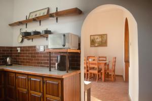 a kitchen with a microwave and a table with chairs at The Meadow Manor in Port Edward