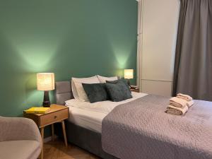 a bedroom with a bed and a couch and a chair at Reval Residences City Center in Tallinn