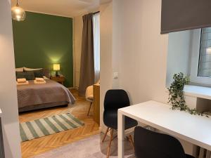 a bedroom with a bed and a table and chairs at Reval Residences City Center in Tallinn +66 photos
