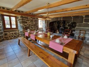 a dining room with a table and a fireplace at La Maison de Julia in Blanzac +9 photos