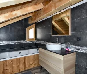a bathroom with a sink and a bath tub at Chalet Loan in Montgenèvre +25 photos