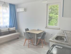 a kitchen and living room with a table and chairs at Kristan in Sveti Vlas