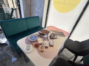 a table with plates of food on top of it at HIQ Hotel Home Inn Qusar in Qusar +8 photos