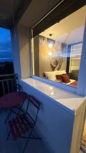 a room with a window with a chair and a bed at Apartament Centrum Ligota in Katowice
